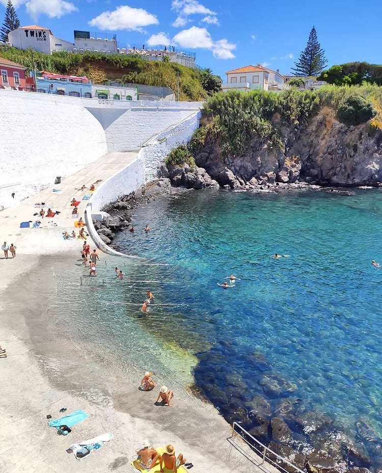Tourists enjoying the man-made beach at Cais da Silveira, Azores