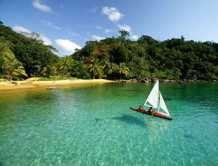 People sailing over crystal clear water in Masoala National Park