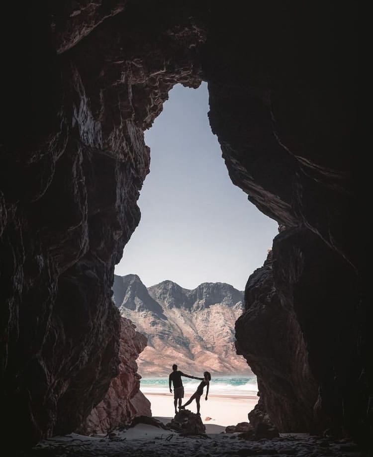 A couple dances in a beach cave at Dappat se Gat, Koggelbay