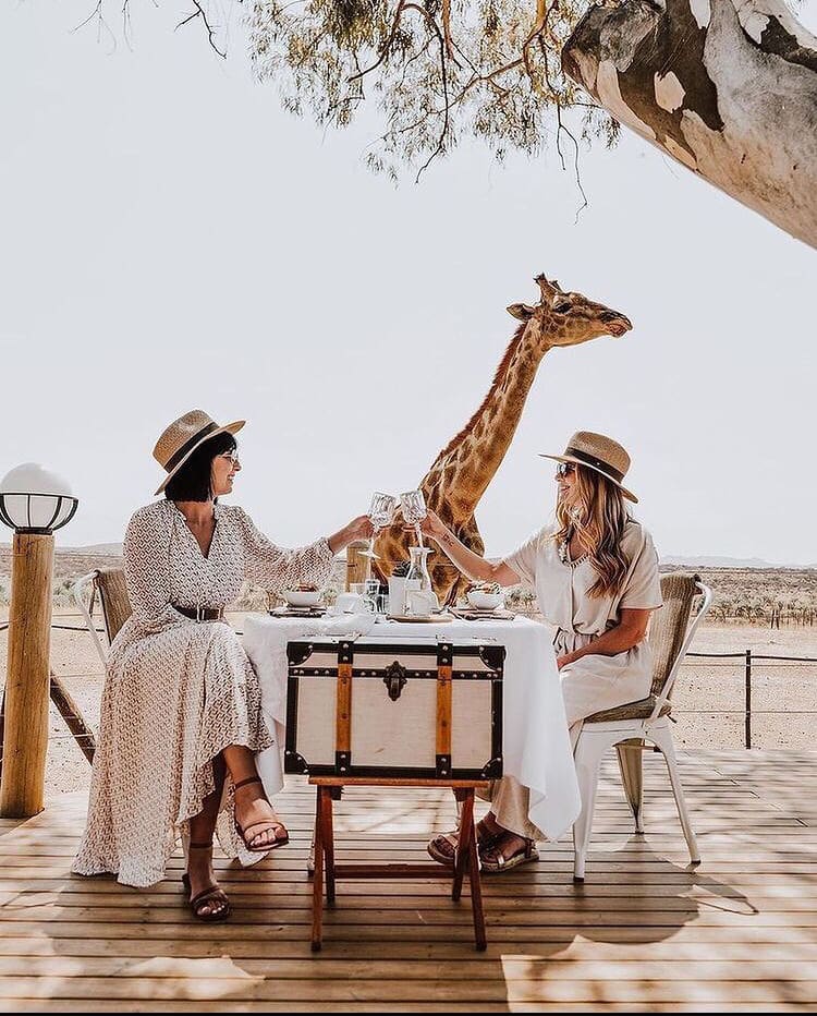 An idyllic lunch spot with a giraffe visitor