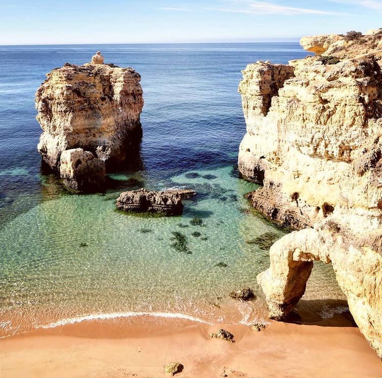 Rock formations and blue waters at Praia de Sao Rafael