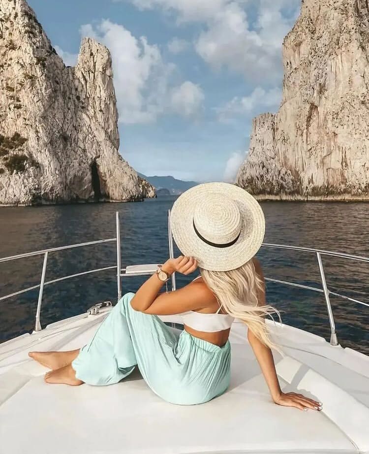 A young woman enjoying a boat trip in Capri - The 12 Best Places to Visit in the South of Italy