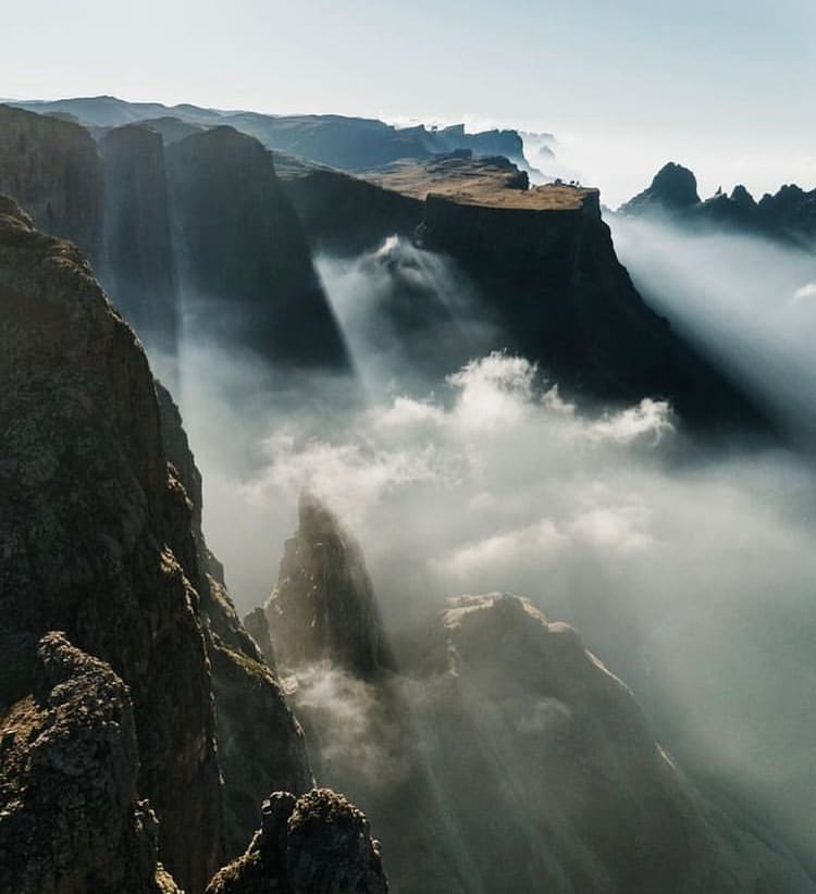 Winter mist flows through the Drakensberg Mountains