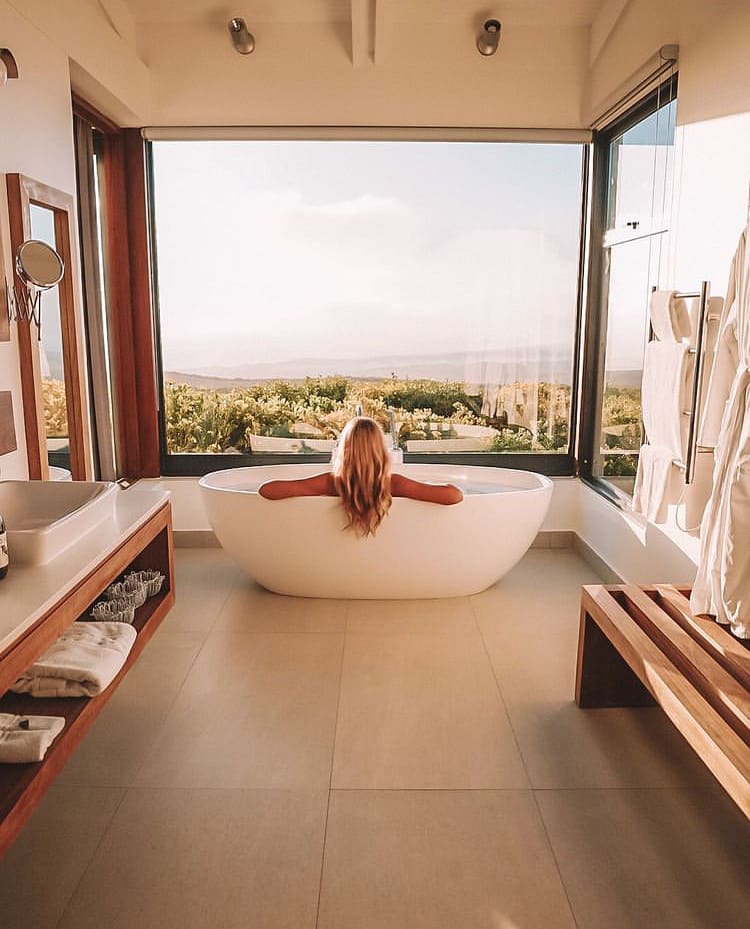 A woman enjoys a bath with a view in Grootbos Private Nature Reserve - The best places for a safari near cape town