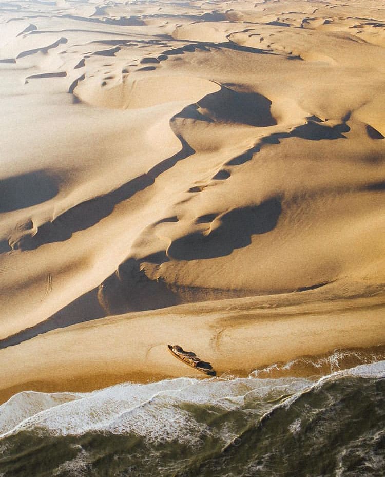 Aerial views of a shipwreck and the desert in Skeleton Coast National Park - The Best Places to See Wildlife in Namibia