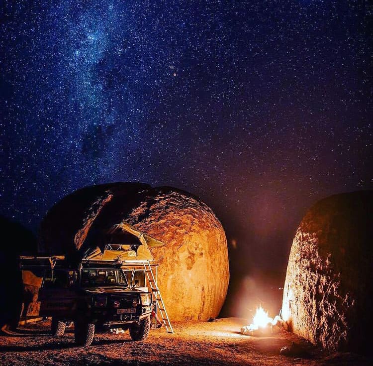 Land cruiser and camp fire set up under the star-filled Namibian sky - The Best Places to See Wildlife in Namibia