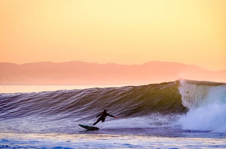 A surfer catching an early morning wave at Jeffrey's Bay - The 10 Best Places to Surf in South Africa