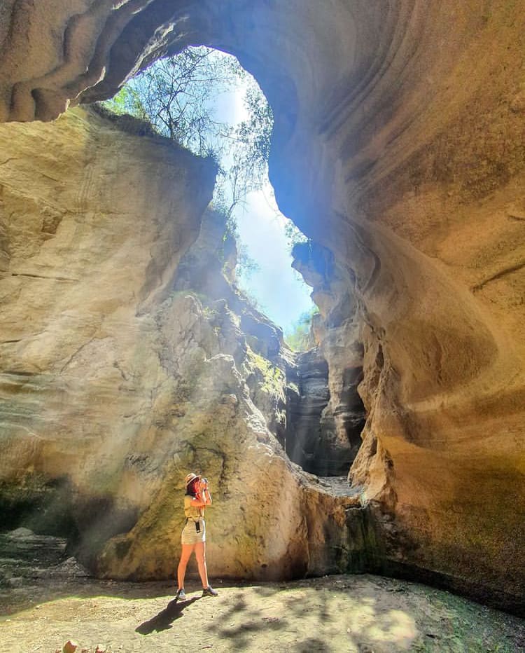 Exploring a giant cave in Hell's Gate National Park - The Best Things To Do in Nairobi, Kenya