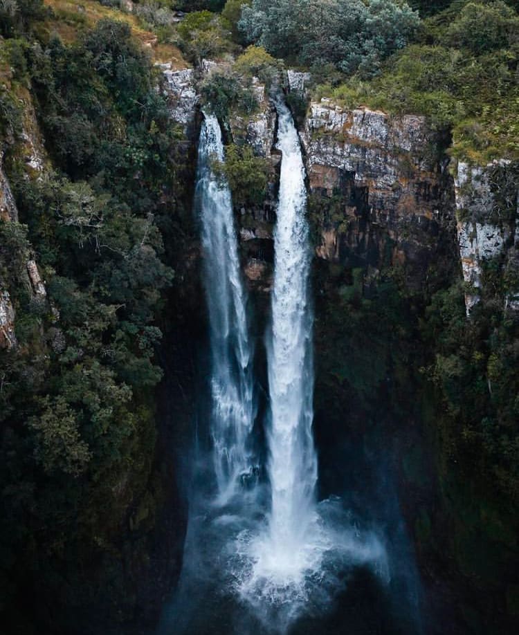 Water gushes off the side off a mountain side at Mac-Mac Falls