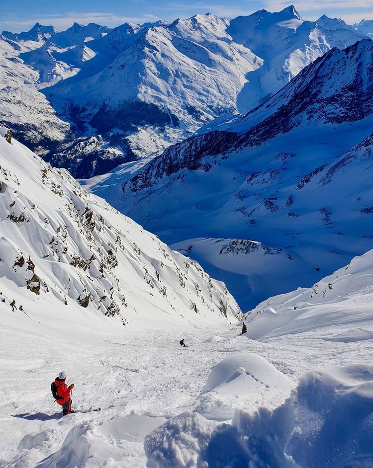 Skiing down a sunnty slope in Les Arcs - The Top 9 Places to Ski in France