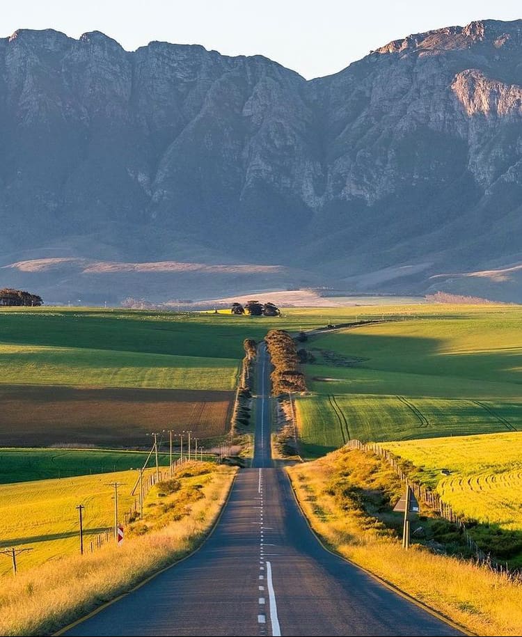 The sun sets over picturesque farmland in South Africa's wine region