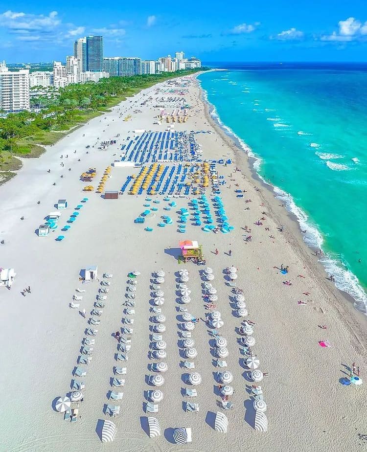 Beach chairs and umbrellas spread out over Miami Beach, Florida