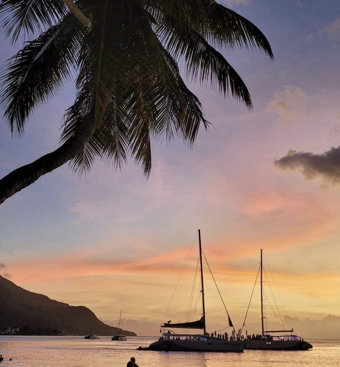 Yachts cruise the shallow waters off Beau Vallon Beach, Seychelles