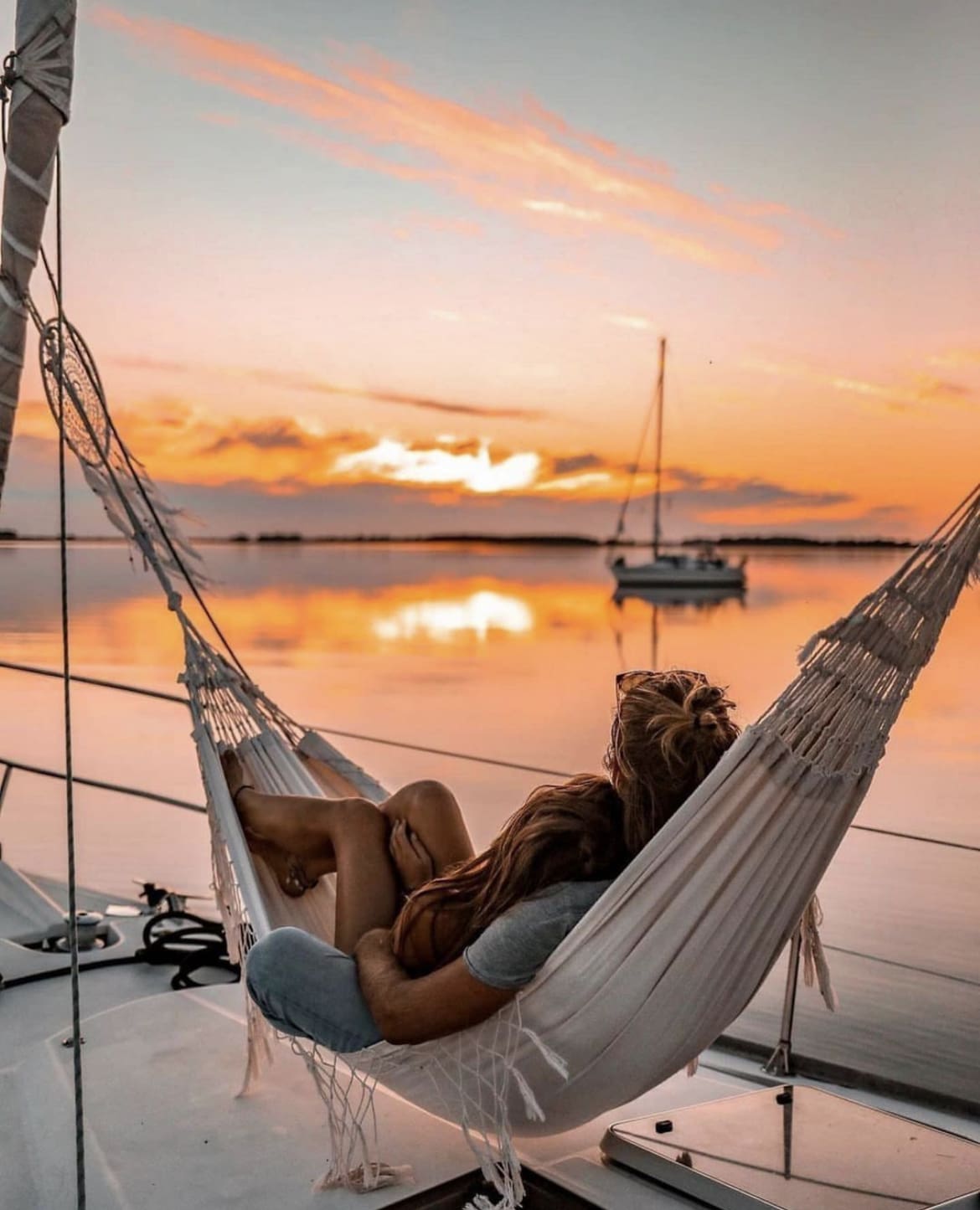 Couple on honeymoon in portugal watching the sunset from a hammock