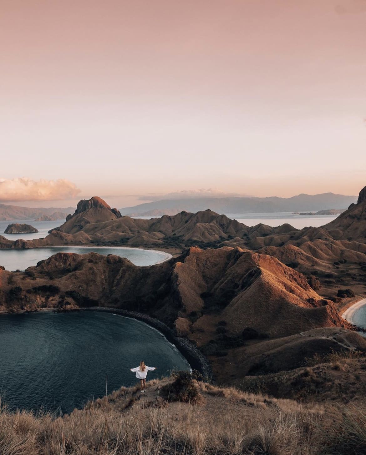 A girl looks over at the view of Komodo Island, Indonesia