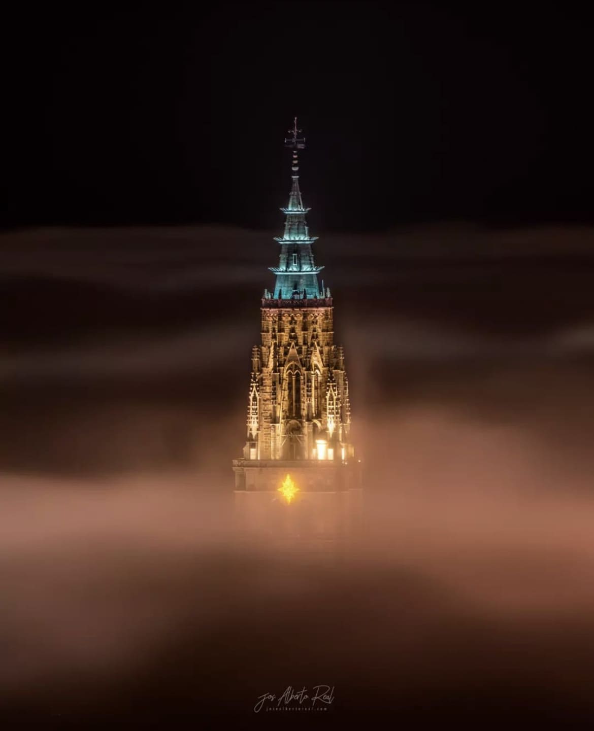 Catedral de Santa Maria de Toledo poking out through the clouds - Must-See Tourist Attractions in Spain