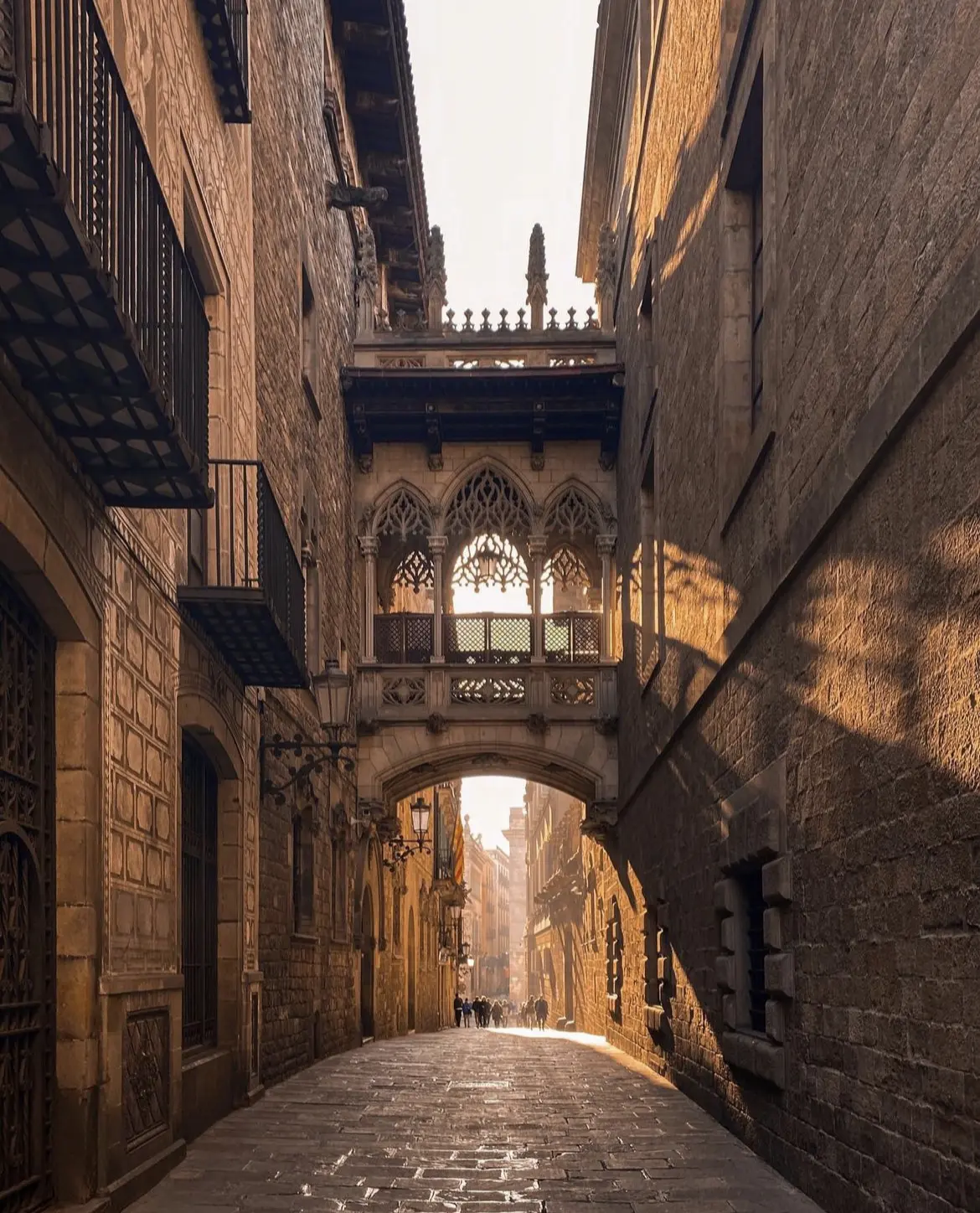 The sun rises between the buildings in Barcelona