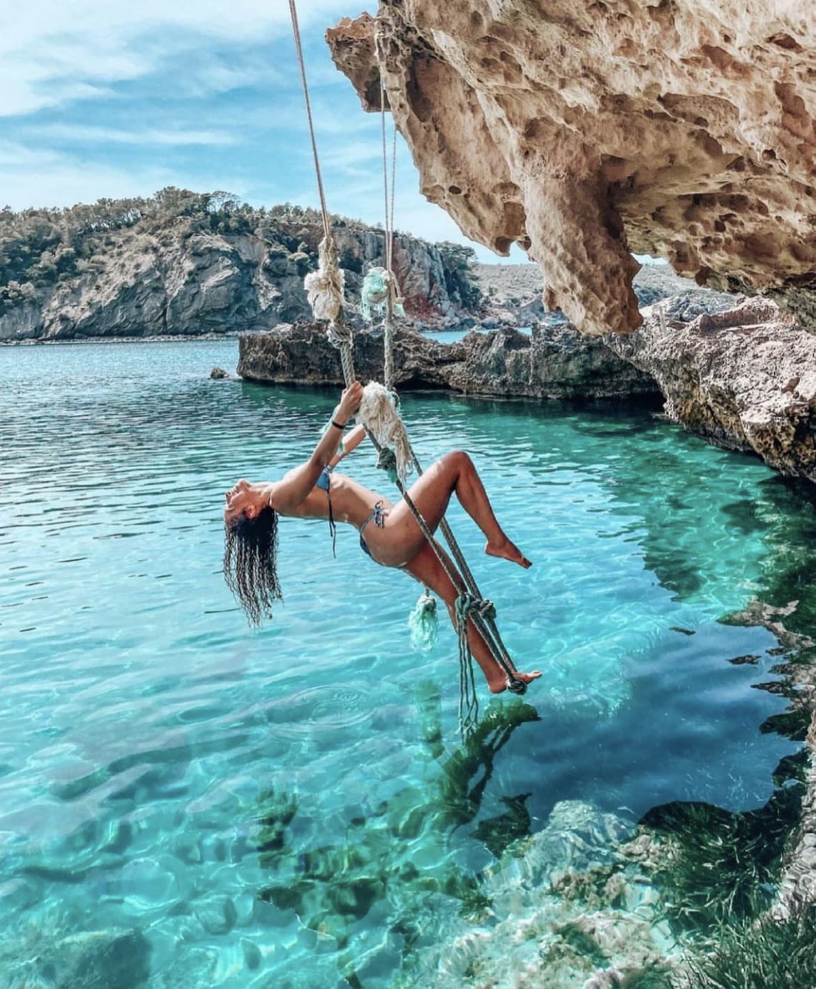 Rope swing over the sea, Ibiza - the best time to visit Spain