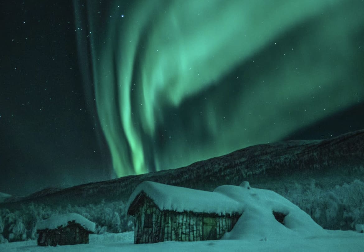 Picturesque cabin under the Northern Lights